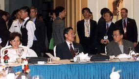 Tanaka sits with colleagues from N. and S. Koreas